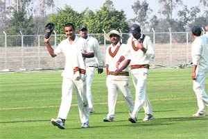 Haryanas Harshal Patel (8-34) leaves the field after Rajasthans innings in Rohtak on Tuesday. 