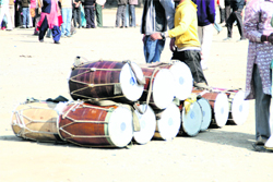 Drums beaters who are in demand for nomination processions are waiting to be hired at the Parade Ground in Dehradun 
