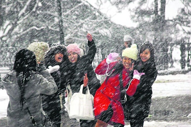 Girls frolic during heavy snow in Shimla on Wednesday.