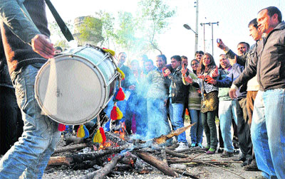 Students celebrate Lohri at the Directorate of Distance Education in the University of Jammu on Wednesday. 