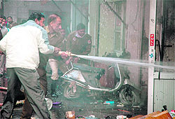 Firemen labour hard to douse flames at a chemist shop in Jalandhar on Tuesday