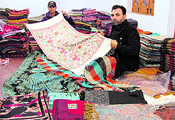 Abdul from Kashmir displays a shawl in Ludhiana