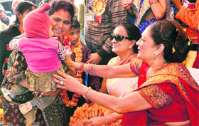 Prime Minister of Trinidad and Tobago Kamla Persad Bissessar comforts a child during a visit to her ancestral village Bhelupur in Buxar district of Bihar on Wednesday.