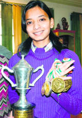 Neha Gaikwad, a student of Khalsa College for Women with her medals and trophy. 