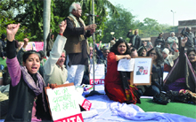 Teachers, under the banner of DUTA, shout slogans against the VC of Delhi University during a dharna outside his office in New Delhi on Thursday. 