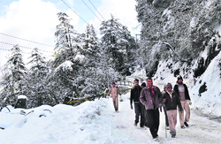 People walk as roads remained blocked in Shimla