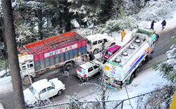 An oil tanker skids on a snow-covered road in Shimla