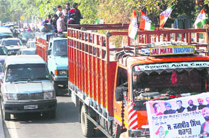 Commuters stuck in a traffic jam as a convoy of Jagbir Brar passes through Bhagwan Mahavir Marg in Jalandhar on Thursday. 