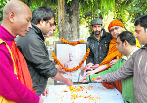 Activists of the Sangharsh pay floral tributes to Swami Vivekananda on his birth anniversary at the University of Jammu on Thursday. 