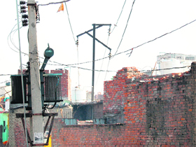 High-tension wires pass over houses near Indira Colony in the Amritsar (North) constituency.