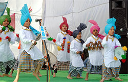Students present a folk dance during a function on Lohri which was organised by the Baba Farid College of Management at the institutions campus in Bathinda on Friday