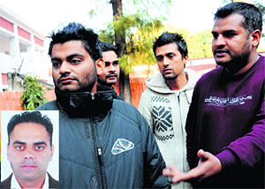 Amrinder Singh, brother of Harminder (inset), with relatives in Chandigarh on Friday.