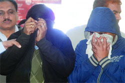 The two doctors, arrested in connection with their role in the recent leaking of question papers of the All India Institute of Medical Sciences (AIIMS) entrance examinations, after being produced at the Patiala House courts in New Delhi on Friday. 
