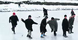 Children play on the frozen surface of the Dal Lake in Srinagar on Friday, even as the authorities have issued an advisory not to attempt to walk or skate on the frozen surfaces of lakes, ponds or rivers.