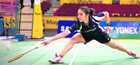 Saina Nehwal hits a return against Tine Baun of Denmark in the women's singles quarterfinal match at the Malaysia Open Badminton super series in Kuala Lumpur on Friday. Saina won in three sets.