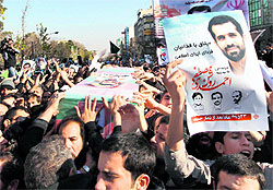 Mourners carry the coffin of nuclear scientist Mostafa Roshan during his funeral in Tehran on Friday