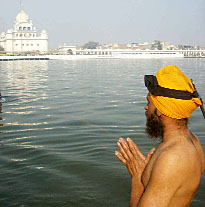 A devotee prays at Gurdwara Tutti Gandi Sahib in Muktsar on Saturday. A Tribune photograph