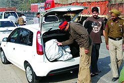 A policeman checks a vehicle as a security measure in Bathinda. 