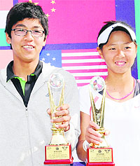 Hyeon Chung (KOR) and Ching Wen Hsu (TPE) strike a pose with trophies of the ITF Junior Circuit Grade-3 at CLTA, Sector 10, Chandigarh on Saturday