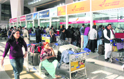 Stranded passengers in front of the Air India counter as many flights were cancelled due to pilots strike at the Indira Gandhi International Airport in New Delhi on Monday