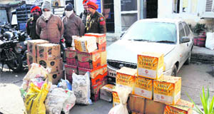 The accused with seized liquor in police custody in Ludhiana. 
