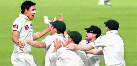 Australias Mitchell Starc (L) celebrates the wicket of Gautam Gambhir in Perth on Saturday.