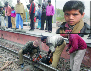 Workers repair the railway track at Mandawali Chander Vihar, after Deepak (inset) informed the officials of cracks on the track in east Delhi on Sunday.