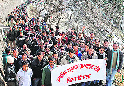 Activists of the Primary Helper Teachers Association hold a rally in Shimla on Saturday