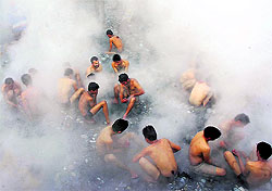 Devotees bathe in a natural hot water spring on the banks of the Sutlej on Makar Sankranti at Tatapani, 52 km from Shimla, on Saturday