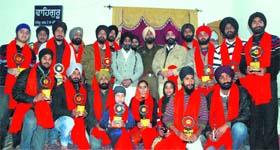 Meritorious Sikh students pose for a photograph after being felicitated by the management committee of Gurdwara Sri Kalgidhar in Jammu on Sunday