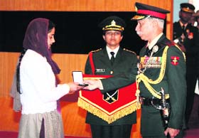 Lance Naik Sanjay Kumars widow Neelam Kumari receives the Sena Medal (Gallantry), awarded posthumously, from GOC-in-C of the Northern Command Lt Gen KT Parnaik during a ceremony at Akhnoor on Sunday