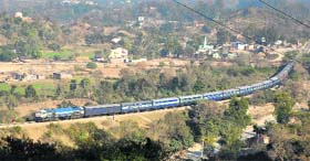 A train moves on the Jammu-Udhampur section even as road traffic was affected by landslides on Sunday