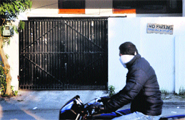 A motorcyclists moves past a hoarding stating No parking, tyres would be deflated on Dr Sham Singh Road in Ludhiana, on Sunday. 