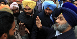 SAD chief Sukhbir Singh Badal interacts with public during his election campaign in Jalalabad on Monday.