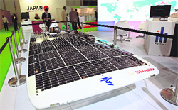 A man stands near the Total Challenge, the world's fastest solar car that was built by students of Japan's Tokai University in 2009, at the Future Energy exhibition being held on the sidelines of the World Future Summit in Abu Dhabi, UAE 