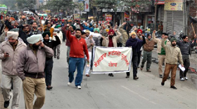 Members of the Unemployed Linemen Union staging a protest march in favour of their demands in Bathinda on Monday. The protest caused traffic jams in the city.