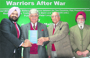 Former Army Chief Gen VP Malik (second from left), along with Tridivesh Singh Maini (left), releases a book Warriors After War in Chandigarh on Monday. Tribune photo: S Chandan