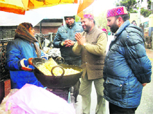 Upendar Thapli, husband of Godavari Thapli, a rebel Congress candidate, seeks votes in her favour in Mussoorie on Monday. 