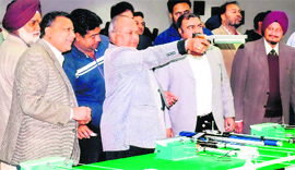 Dignitaries practice shooting at the inauguration of the newly renovated PAP range in Jalandhar.