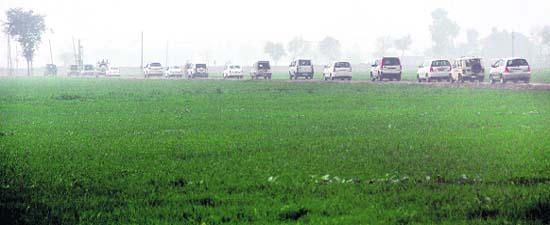 SAD chief Sukhbir Badals cavalcade moves through a village in Jalalabad constituency and (top) villagers present him a 'siropa'