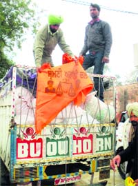 Election authorities unload the seized SAD publicity material at a village in Lambi constituency on Monday