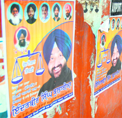 In poll code violation, Inderbir Bolaria's posters dot the boundary wall of a public park near Galwali Gate in Amritsar on Tuesday.