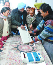 Government employees, deputed for poll duties, at a training camp.