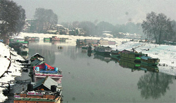 The frozen Dal Lake melted away following sunshine in Srinagar on Tuesday.