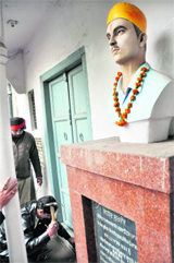 Employees of the administration break locks of the Shaheed Sukhdev Thapars house; and (right) 