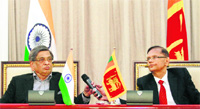Sri Lankas Foreign Minister Gamini Lakshman Peiris (R) with his Indian counterpart SM Krishna during their meeting in Colombo 