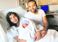 The New Jersey couple with their baby boy born on the 9.49 am PATH train, in New York 