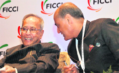 Finance Minister Pranab Mukherjee (L) with FICCI president-elect R.V. Kanoria at the chambers 84th AGM in New Delhi 