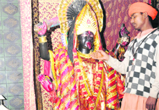 A priest points to the theft of jewellery and cash box from the temple at Sector 19 in Chandigarh on Wednesday.