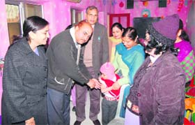 Civil Surgeon SB Kamboj gives measles vaccine to a child in Bal Vatika School at Fatehabad on Wednesday